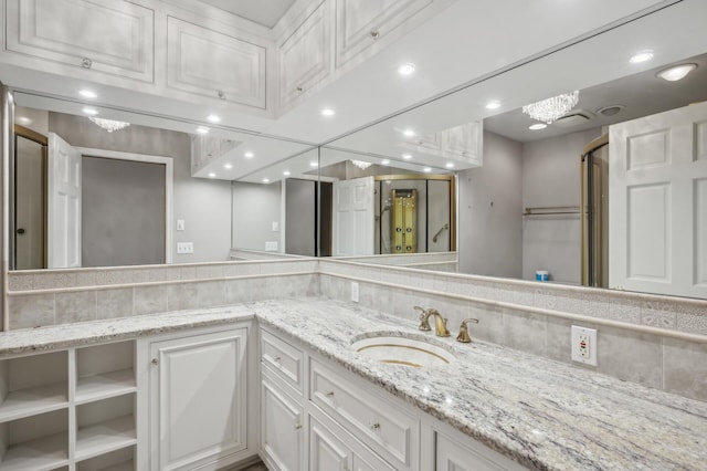 bathroom with vanity and decorative backsplash