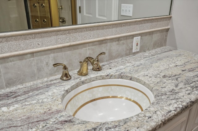 interior details featuring vanity and backsplash