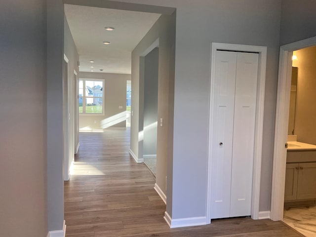 corridor with light hardwood / wood-style floors