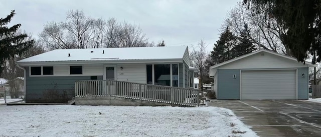 view of front of house with a garage and an outbuilding