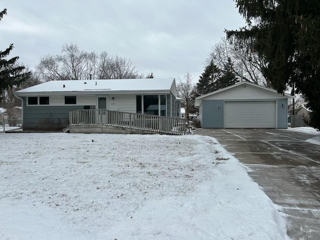 ranch-style house with a garage and an outdoor structure