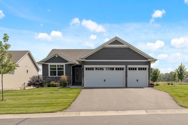 craftsman house featuring a garage and a front yard