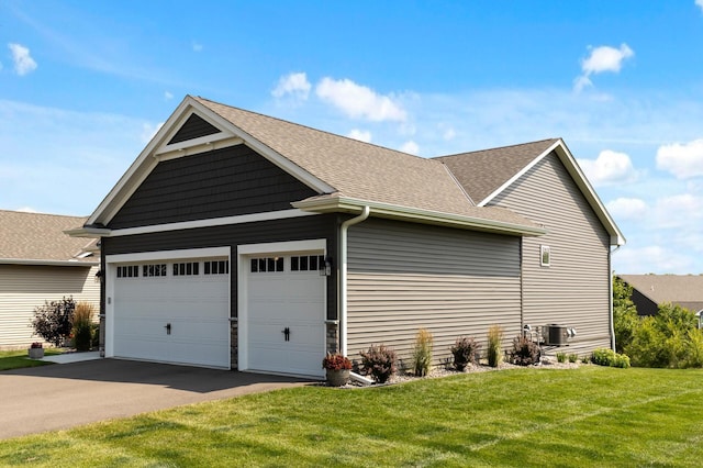 view of side of property featuring cooling unit and a yard