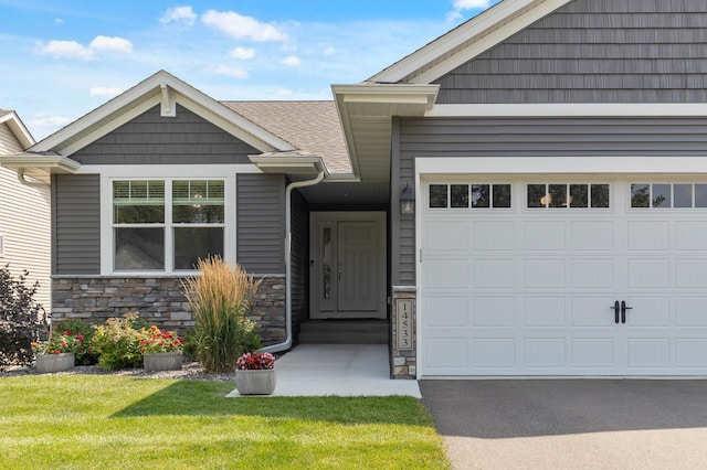 view of front of home with a garage and a front lawn