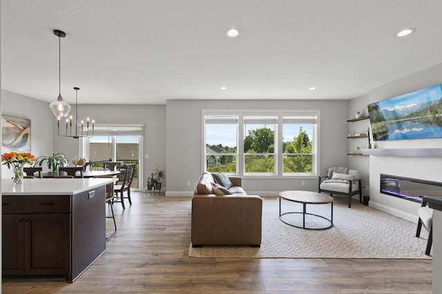 living room featuring an inviting chandelier and hardwood / wood-style floors