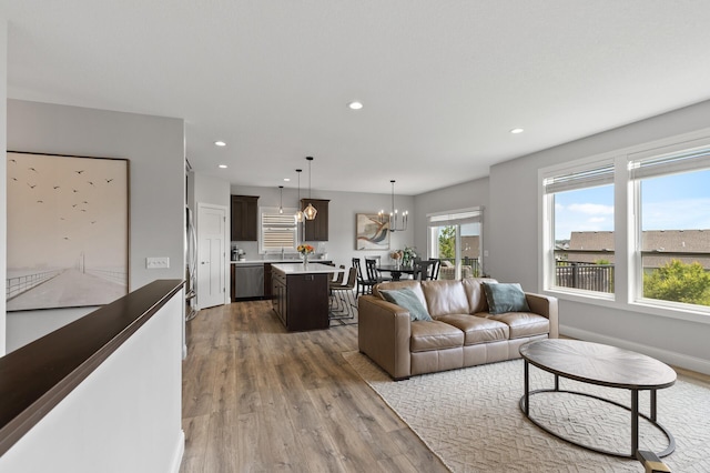 living room with a notable chandelier and dark hardwood / wood-style floors