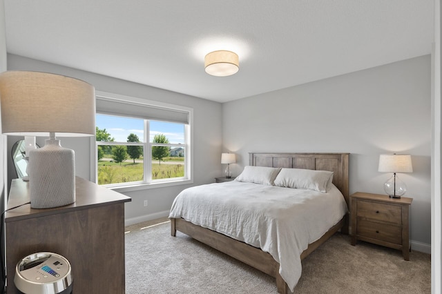 bedroom featuring light colored carpet