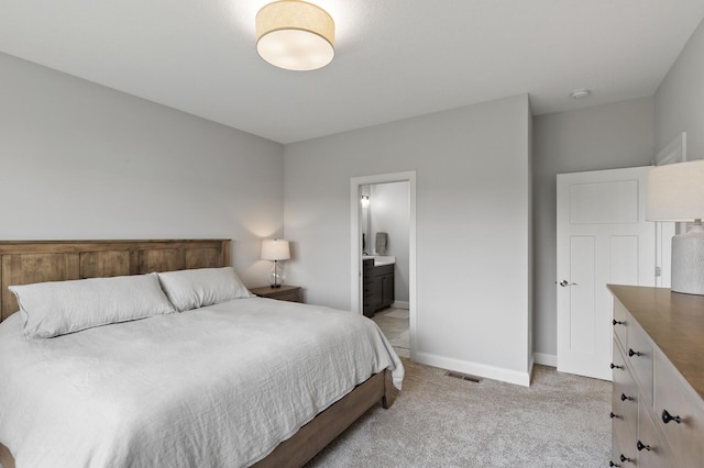 carpeted bedroom featuring ensuite bathroom