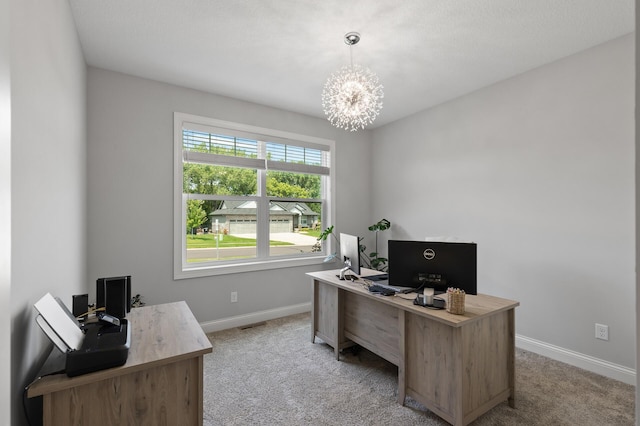 carpeted home office with an inviting chandelier