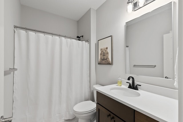 bathroom featuring vanity, curtained shower, and toilet