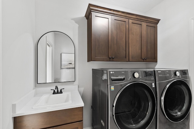 laundry area with cabinets, sink, and washer and dryer