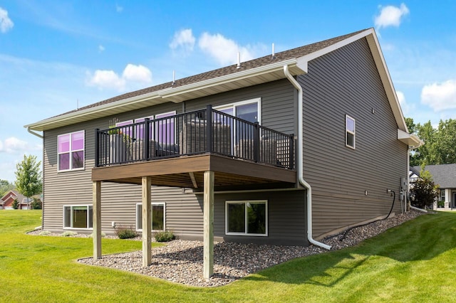 rear view of property with a wooden deck and a yard