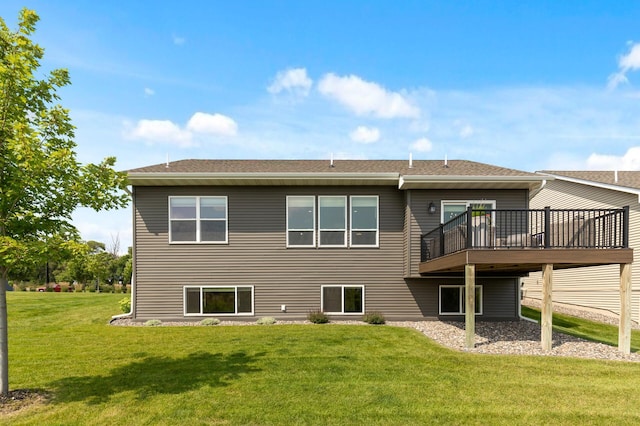 rear view of house with a yard and a deck