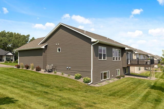 view of side of property with a yard and a deck