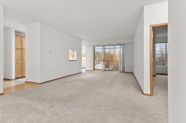 unfurnished living room featuring light carpet