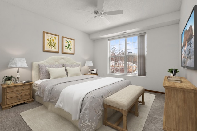 bedroom featuring light carpet, ceiling fan, and a textured ceiling