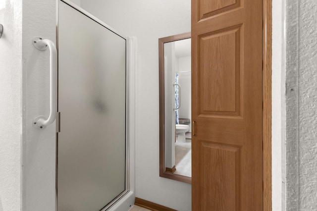 bathroom featuring a shower with door