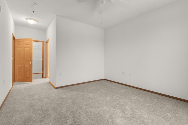 empty room featuring light carpet and ceiling fan