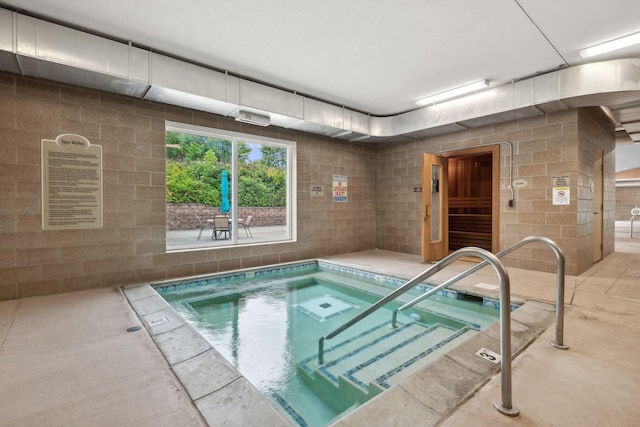 view of swimming pool with an indoor in ground hot tub