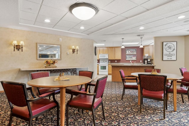 dining room with a drop ceiling