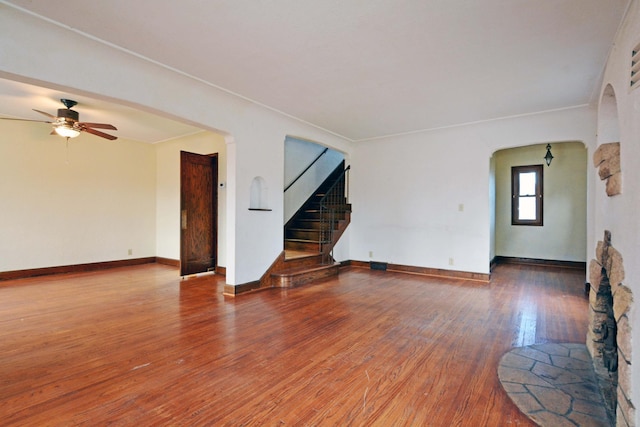 empty room with hardwood / wood-style floors and ceiling fan