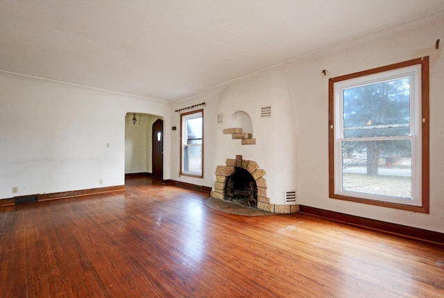 unfurnished living room with hardwood / wood-style floors and a fireplace