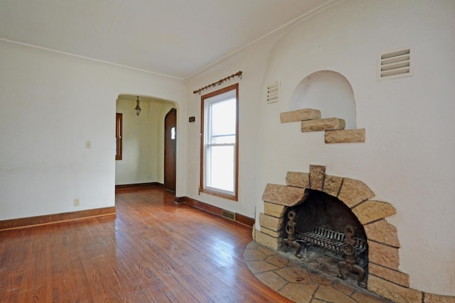 unfurnished living room with crown molding and hardwood / wood-style floors