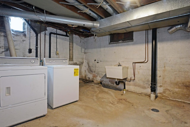 basement featuring sink and washer and dryer