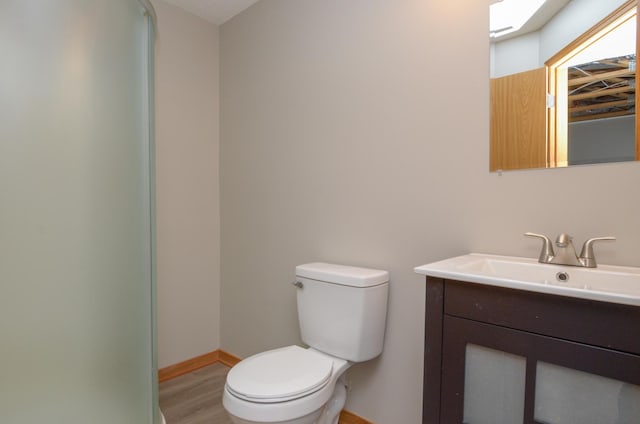 bathroom featuring hardwood / wood-style flooring, vanity, and toilet