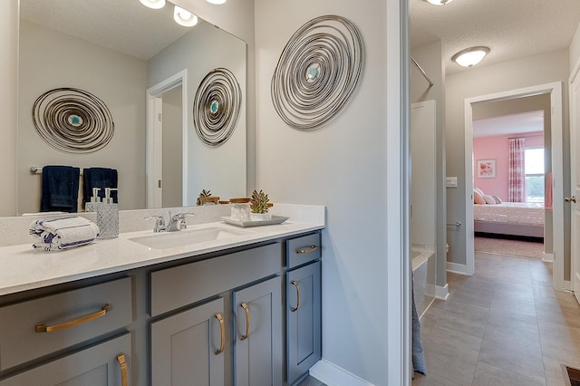 bathroom with vanity and a textured ceiling