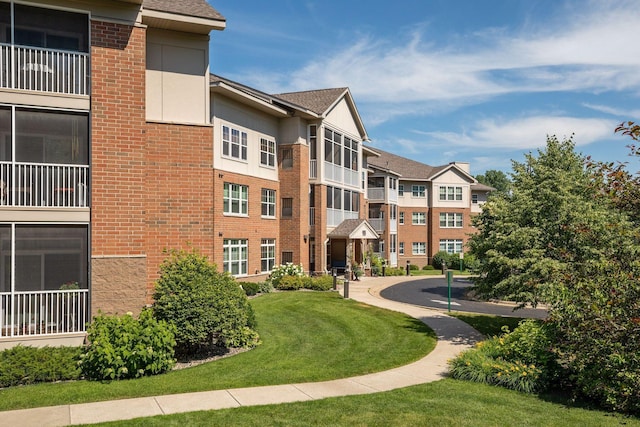 view of home's community featuring a lawn