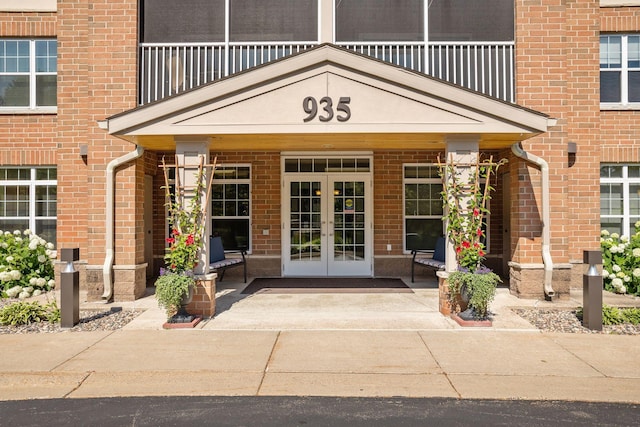 property entrance featuring french doors and a balcony