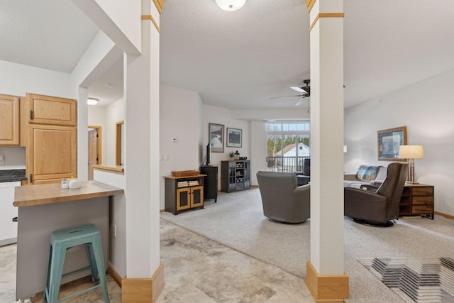 living room with light colored carpet, a textured ceiling, and ceiling fan