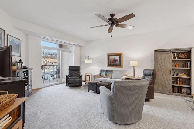 carpeted living room with ceiling fan