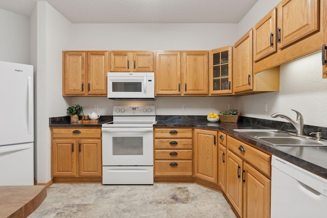 kitchen featuring white appliances and sink