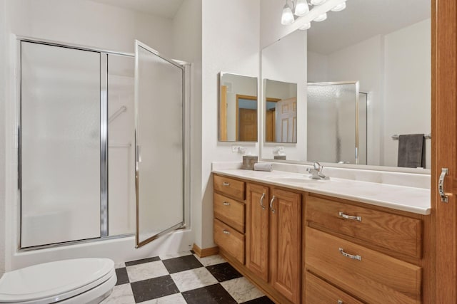 bathroom with vanity, toilet, and an enclosed shower