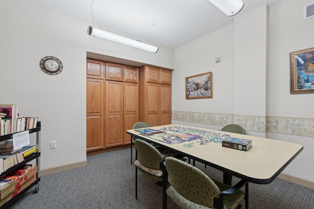 home office featuring dark colored carpet