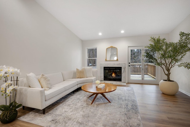 living room featuring hardwood / wood-style flooring and a high end fireplace