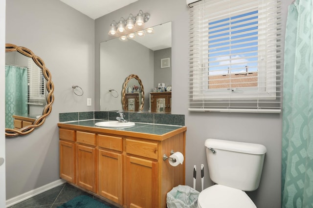 bathroom with tile patterned flooring, vanity, and toilet