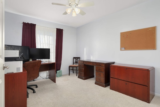 carpeted office space featuring ceiling fan