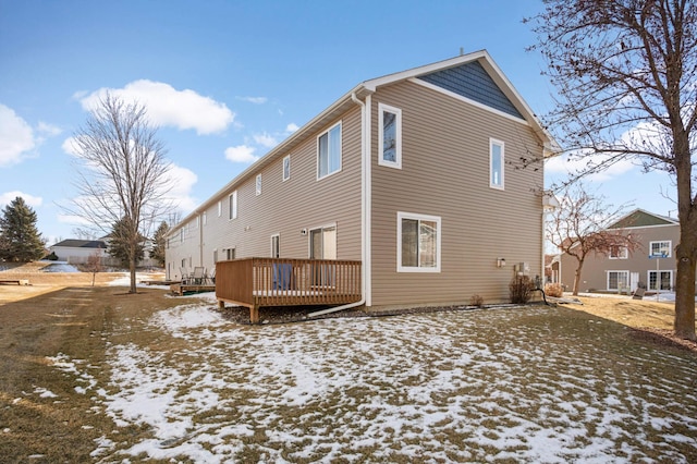 snow covered property with a deck