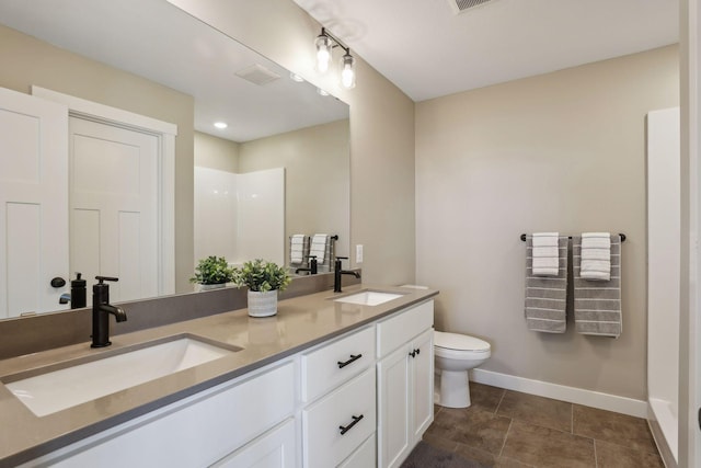 bathroom with vanity, a shower, and toilet