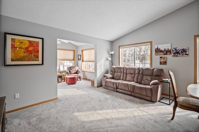 living room featuring carpet, vaulted ceiling, a textured ceiling, and baseboards