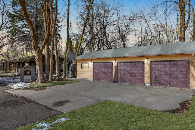 view of garage at dusk