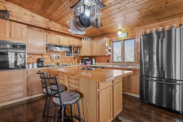 kitchen with light brown cabinetry, sink, wooden counters, a center island, and stainless steel appliances