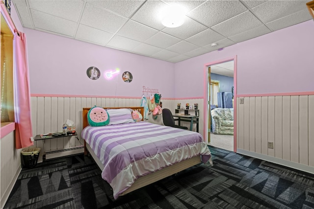 bedroom featuring carpet floors and a drop ceiling