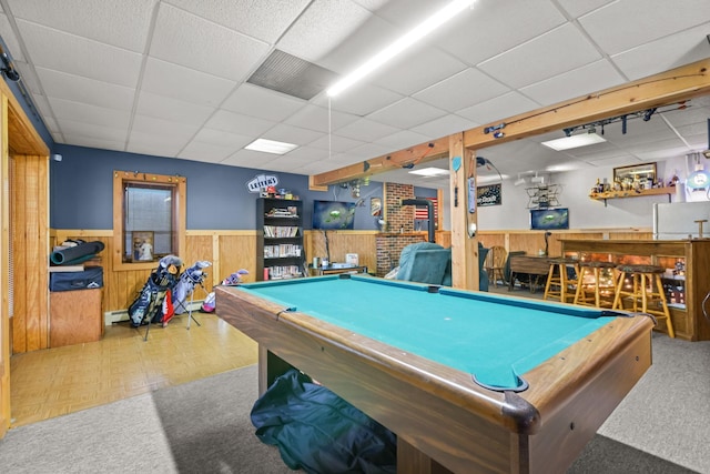 playroom featuring wood walls, bar area, billiards, and a drop ceiling