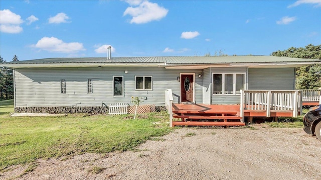 view of front of property with a front lawn and a deck