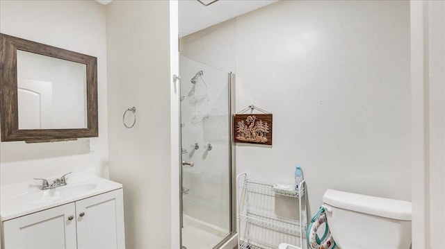 bathroom with vanity, toilet, and a shower with shower door