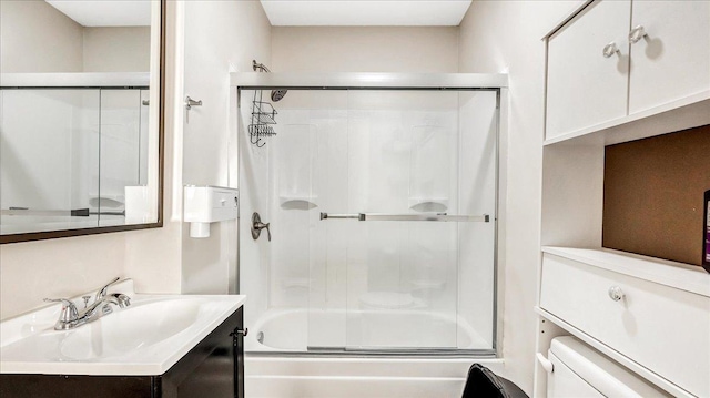 full bathroom featuring vanity, toilet, and combined bath / shower with glass door